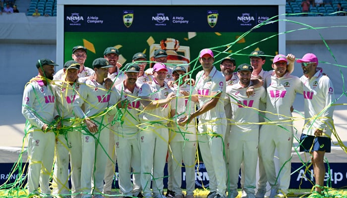 Australian players celebrate with the Waterford Crystal Ashes Trophy at the end of the fifth Ashes Test between Australia and England at Sydney Cricket Ground on January 8, 2026. — AFP