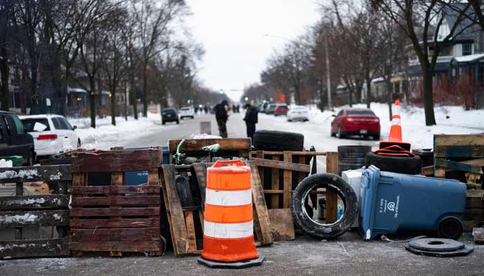 Barricades blocks the street near the site where Renee Nicole Good was shot and killed on January 08, 2026 in Minneapolis. — AFP