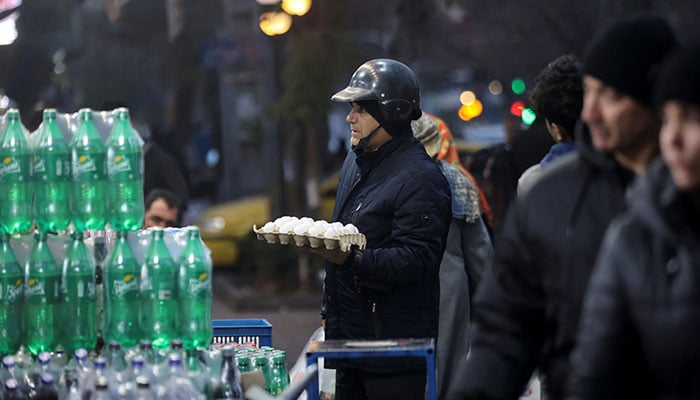An Iranian man shops in a local market as protests erupt over the collapse of the currencys value in Tehran, Iran, January 5, 2026. — Reuters