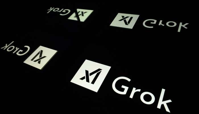This photograph shows screens displaying the logo of Grok, a generative artificial intelligence chatbot developed by US artificial intelligence company xAI. — AFP