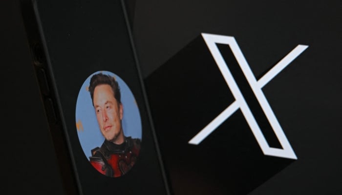 This illustration photograph shows the logo of social network X (formerly Twitter) and a photograph of  Elon Musk displayed on a smartphone in Brussels on September 27, 2024. — AFP