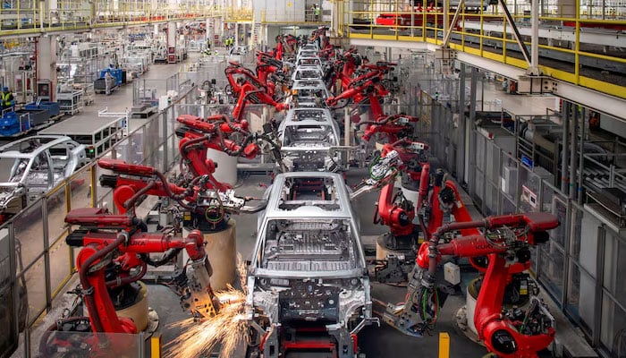 Robotic arms assemble cars in the production line for Leapmotors electric vehicles at a factory in Jinhua, Zhejiang province, China. — Reuters/File