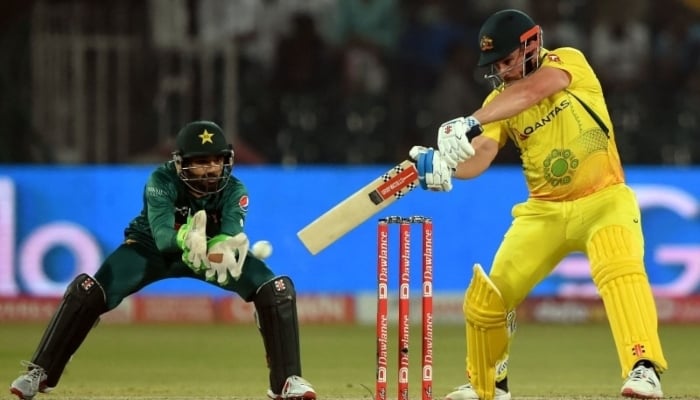 Australias Aaron Finch (right) plays a shot as Pakistans Mohammad Rizwan watches during the Twenty20 international cricket match between Pakistan and Australia at the Gaddafi Cricket Stadium in Lahore on April 5. — AFP
