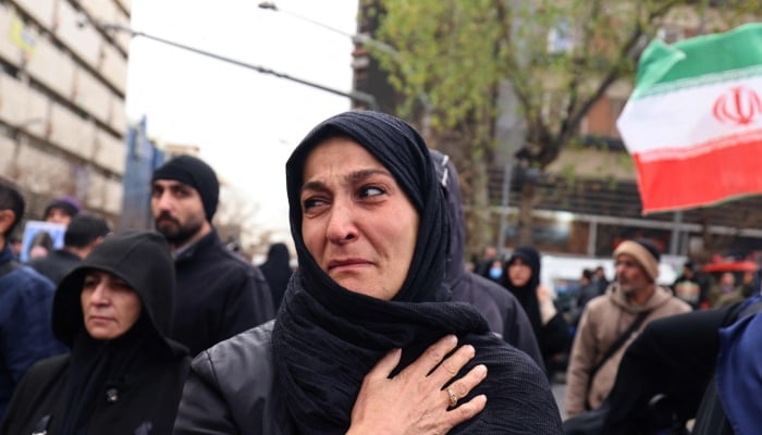 An Iranian woman mourns during the funerals of security forces personnel killed in recent protests in Tehran, January 14, 2026. — AFP