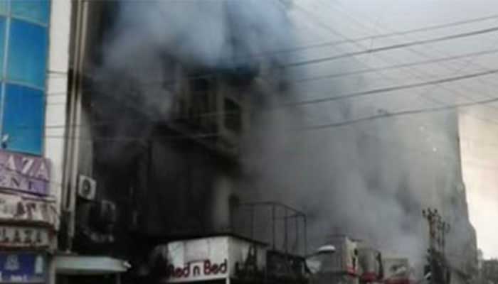 Smoke billows from a building after a massive fire engulfs a shopping mall on Karachis MA Jinnah Road on January 17, 2026. — Geo News