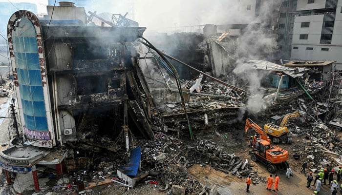 Rescue workers search amid the debris using excavators after a massive fire at a shopping mall in Karachi on January 19, 2026. — AFP