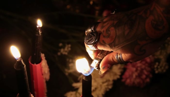 A self-proclaimed witch lights a candle in Brooklyn, New York, US. — Reuters/File