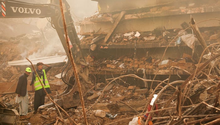 A municipal worker reacts as he clears the site, following a massive fire that broke out in the Gul Plaza Shopping Mall in Karachi, January 20, 2026. — Reuters