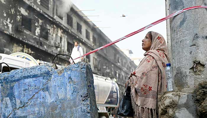 A woman (R) mourns a relative who died at Gul Plaza shopping mall fire in Karachi on January 20, 2026. — AFP