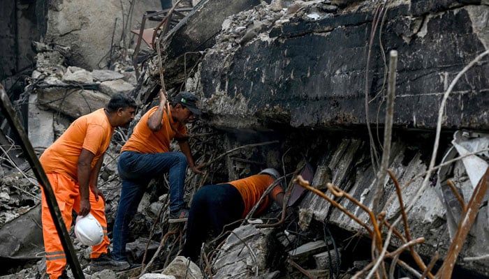 Rescue workers search for bodies among the rubble after a massive fire broke out Gul Plaza shopping mall in Karachi on January 21, 2026. — AFP