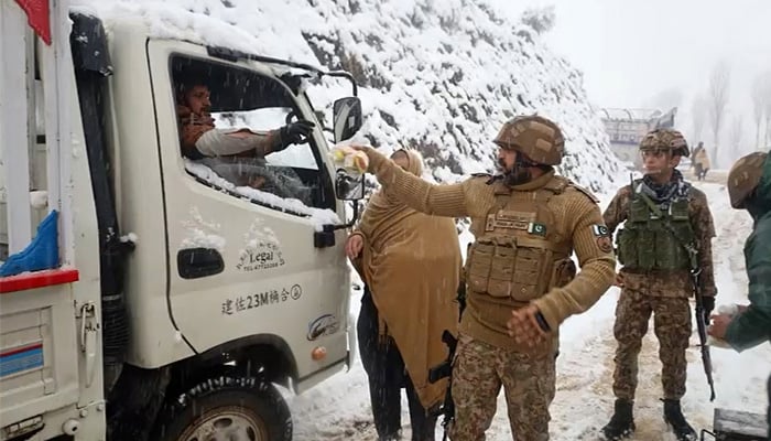 Pakistan Army personnel assist families evacuating homes along snow-covered roads amid heavy snowfall and freezing cold in Tirah Valley, Khyber Pakhtunkhwa, January 23, 2026. — Reporter