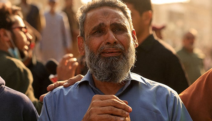 Shafi Ahmed, who owned a store in the basement, grieves for missing friends following a massive fire that broke out in the Gul Plaza shopping centre in Karachi on January 19, 2026. — Reuters
