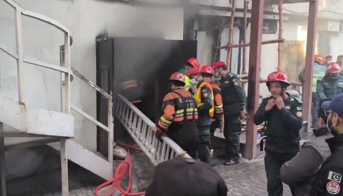 Rescue workers and police officials on site after a fire broke out at a hotel in Gulberg area in Lahore, Punjab, January 24, 2026. — X/@MaryamNSharif