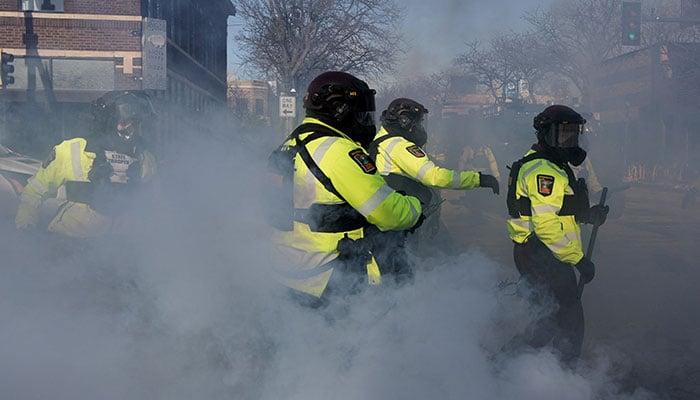 Minnesota State Troopers gather amid tear gas during clashes between federal agents and community members at the scene where federal agents fatally shot a man while trying to detain him, in Minneapolis, Minnesota, US, January 24, 2026. — Reuters