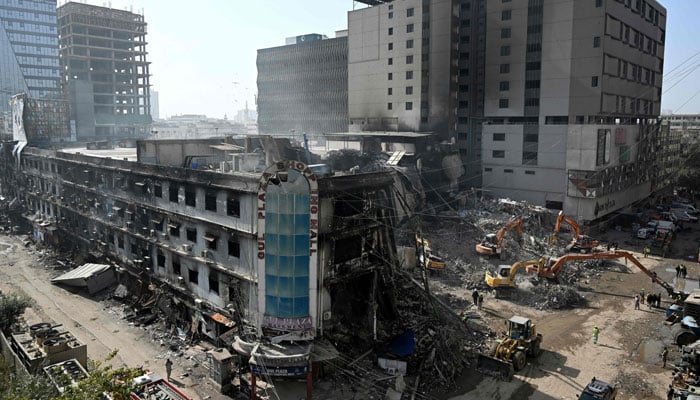 Rescue workers clear debris at charred Gul Plaza shopping mall in Karachi on January 23, 2026. — AFP