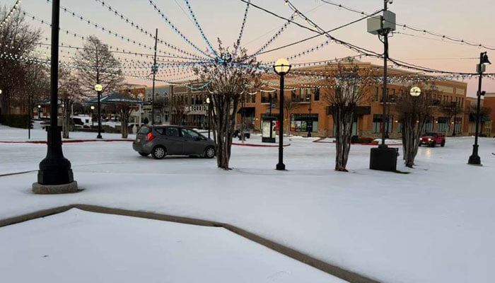 A car drives on a snow-covered road in Texas, US. — Reporter