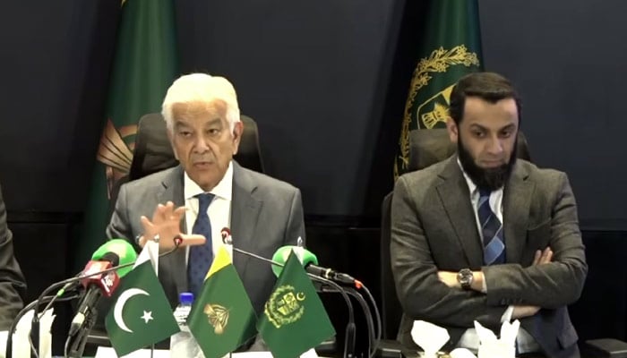 Defence Minister Khawaja Asif (centre) is addressing a press conference in Islamabad on January 27, 2026. — Screengrab via Geo News