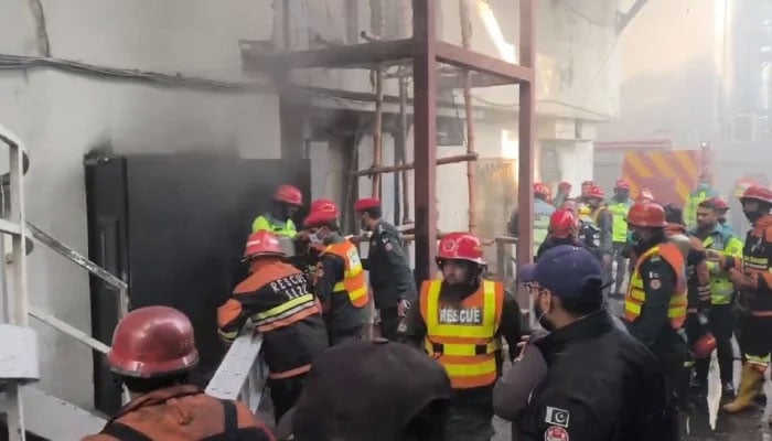 Rescue workers and police officials on site after a fire broke out at a hotel in Gulberg area in Lahore, Punjab, January 24, 2026. — X/@MaryamNSharif