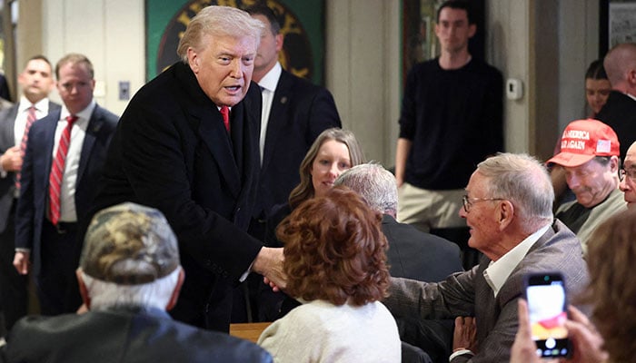 US President Donald Trump greets a man in Machine Shed restaurant in Urbandale, Iowa, US, January 27, 2026. — Reuters