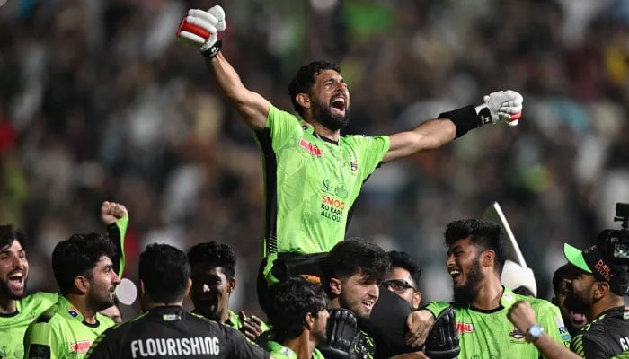 Lahore Qalanders players hoist Sikandar Raza on their shoulders as they celebrate beating Quetta Gladiators to win the Pakistan Super League 2025 at the Gaddafi Stadium in Lahore. — AFP/File