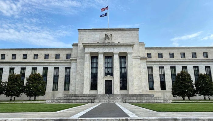 The US and Federal Reserve flags fly on top of the Federal Reserve Board building in Washington, D.C., the US, July 1, 2020. — AFP