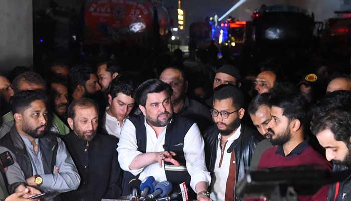 Sindh Governor Kamran Khan Tessori talks to the media about rescue operation on January 19, 2026 outside fire-hit Gul Plaza shopping centre. Muttahida Qaumi Movement-Pakistan senior leader Dr Farooq Sattar is also present. — Facebook/@TeamKTessori
