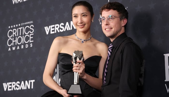 US singer EJAE and US composer Mark Sonnenblick pose in the press room with the Best Song award for KPop Demon Hunters during the 31st Annual Critics Choice Awards at Barker Hangar in Santa Monica, California, on January 4, 2026. — AFP