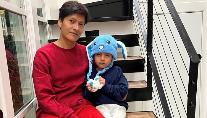 Liam Conejo Ramos and his father Adrian Alexander Conejo Arias, who were detained with his father by immigration officers during a raid in Minnesota and then taken to a detention center in Texas, sit on the stairs back at their home after a judge ordered their release, in Columbia Heights, Minnesota, U.S., in this picture obtained from social media February 1, 2026. — Reuters