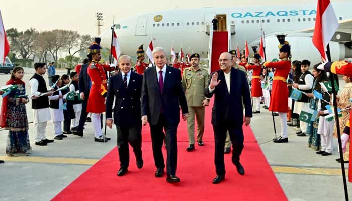 President Asif Ali Zardari (right) and Prime Minister Muhammad Shehbaz Sharif (left) receive Kazakhstan President Kassym-Jomart Tokayev upon his arrival at Nur Khan Airbase on February 3, 2026. — PID