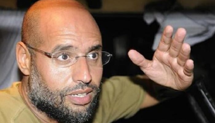Saif al-Islam, son of Libyan leader Muammar Gaddafi, gestures as he talks to reporters in Tripoli, August 23, 2011.— Reuters
