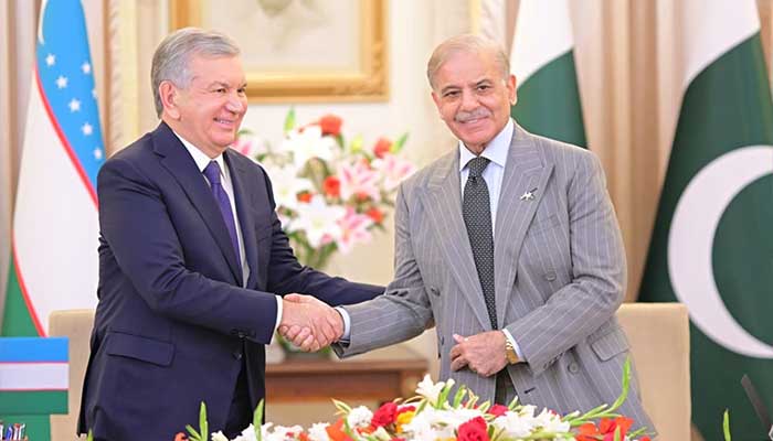 Prime Minister Shehbaz Sharif and Uzbekistan President Shavkat Mirziyoyev shaking hands after both countries signed multiple accords to bolster bilateral ties at Prime Ministers Office, Islamabad, on February 5, 2026. — PID
