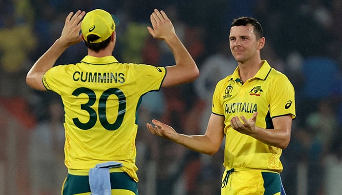 Australias Josh Hazlewood celebrates with Pat Cummins after taking the wicket during their World Cup 2023 clash against England at Narendra Modi Stadium, Ahmedabad, India, November 4, 2023. — Reuters