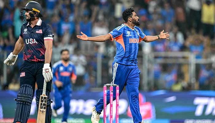 Indias Mohammed Siraj (R) celebrates after taking the wicket of USAs Andries Gous (L) during the 2026 ICC Mens T20 Cricket World Cup group stage match between India and USA at the Wankhede Stadium in Mumbai on February 7, 2026. — AFP