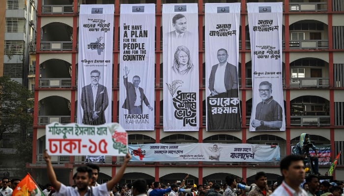 Campaign banners hang on a buildings facade during an election rally of the Bangladesh Nationalist Party (BNP) ahead of the countrys general election in Dhaka on February 8, 2026. — AFP