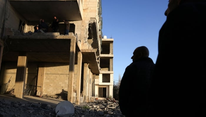 A Palestinian man surveys the remains of the home of Palestinian Mahmud Abed, martyred by the Israeli military in 2025, after it was demolished by explosive devises by the Israeli military, in the village of Halhoul, in occupied West Bank on February 2, 2026. — AFP
