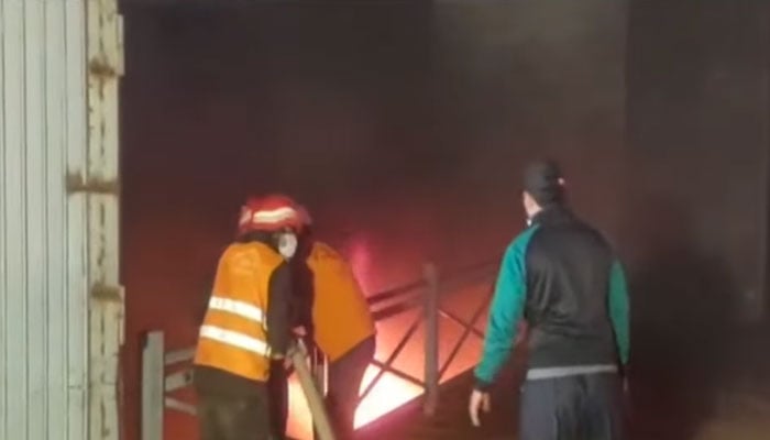 The image shows firefighters busy with operation to extinguish the fire at Rawat factory on February 10, 2026. — Geo News/Screengrab