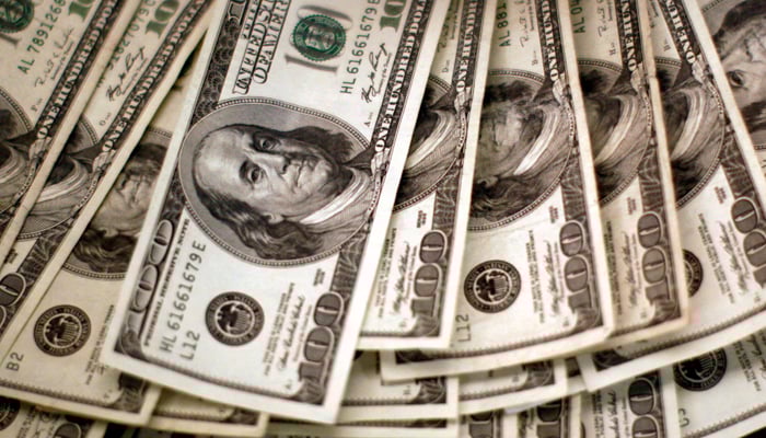 Four thousand US dollars are counted out by a banker counting currency at a bank. — Reuters/File