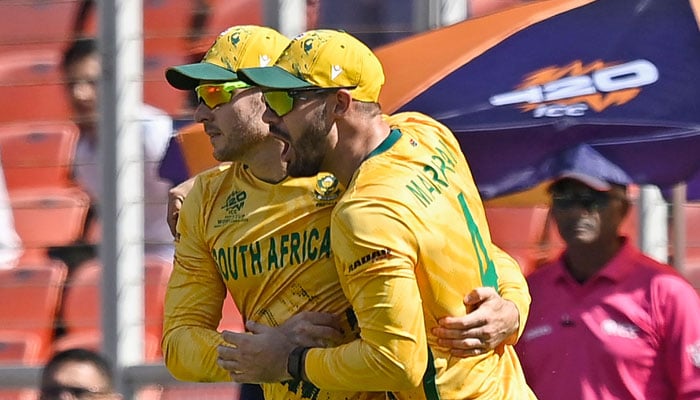 South Africa´s David Miller (left) celebrates with captain Aiden Markram after taking a catch to dismiss Afghanistans captain Rashid Khan during theICC Men´s T20 World Cup  2026 group match at the Narendra Modi Stadium in Ahmedabad on February 11, 2026. — AFP