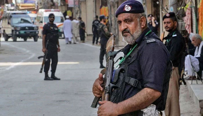 This representational image shows KP police personnel stand guard in Peshawar, on August 7, 2022. — AFP