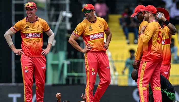 Zimbabwes captain Sikandar Raza (bottom) reacts after an injury as his teammates watch during the 2026 ICC Mens T20 Cricket World Cup group stage match between Australia and Zimbabwe at the R Premadasa Stadium in Colombo on February 13, 2026. — AFP
