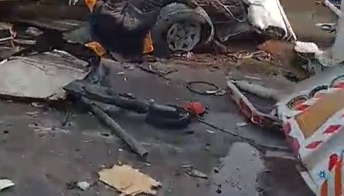 Debris is scattered across the road after a collision involving an oil tanker, a bus and other vehicles on the M9 motorway in Karachi on February 13, 2026. — Reporter