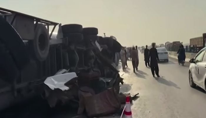 An oil tanker lies overturned after the accident on the M-9 motorway as rescue personnel and law enforcement officials inspect the scene on February 13, 2025. — Screengrab via Geo News