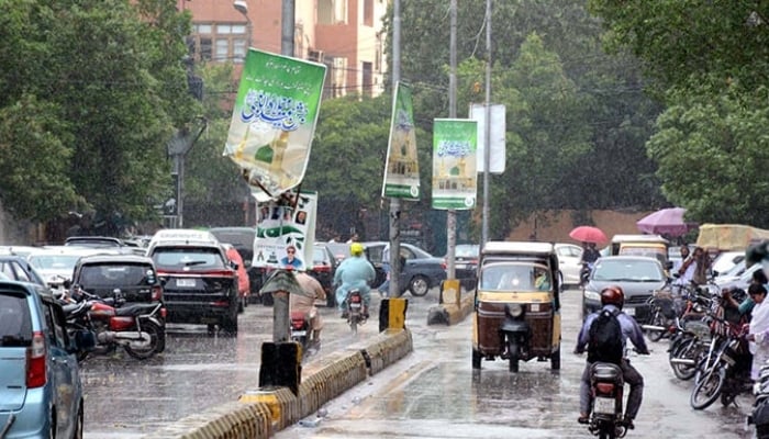 Commuters are passing through a road during the downpour of monsoon season, at Saddar area in Karachi on Tuesday, September 30, 2025. — PPI