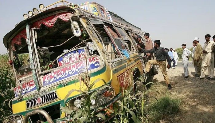 Security officials examine the wreckage of a bus after it crashed into a truck near Pakistan’s central town of Lodhran, some 100 km southwest of Multan, October 10, 2008. — Reuters