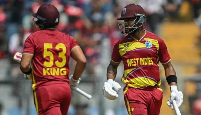 Brandon King (left) and captain Shai Hope run between the wickets during the 2026 ICC Mens T20 Cricket World Cup group stage match against Nepal at the Wankhede Stadium in Mumbai on February 15, 2026. — AFP