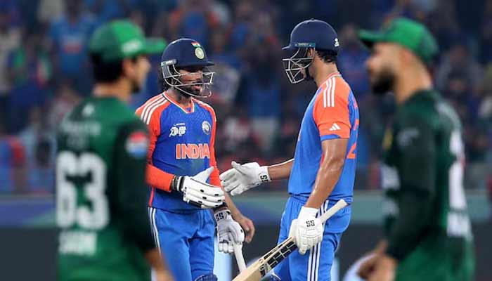 Indias Tilak Varma celebrates after reaching his half century with Shivam Dube. — Reuters