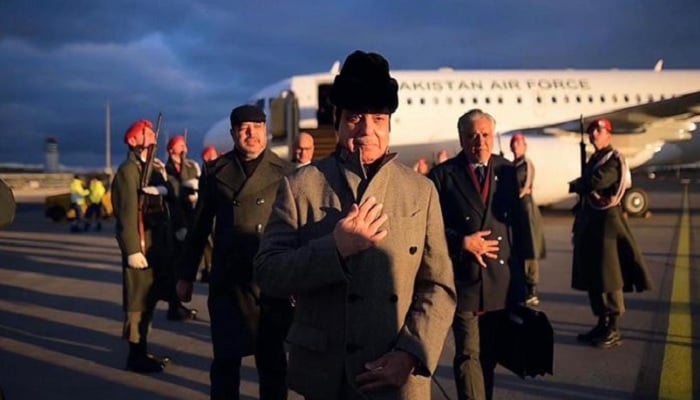 Prime Minister Shehbaz Sharif walks to his official vehicle after arriving in Vienna, Austria, on February 15. — APP