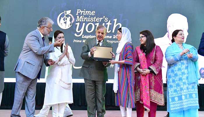 Prime Minister Muhammad Shehbaz Sharif distributing laptops among high achievers of public sector university students under the Prime Ministers Youth Laptop Scheme.— APP