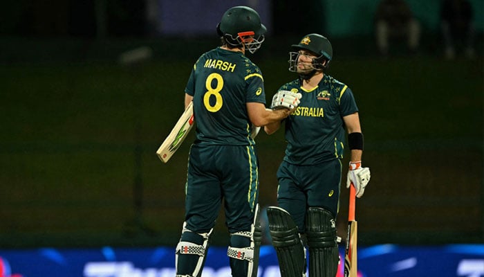 Australia´s Josh Inglis (right) and captain Mitchell Marsh celebrate their team´s win at the end of the 2026 ICC Men´s T20 Cricket World Cup group stage match between Oman and Australia at Pallekele International Cricket Stadium in Kandy on February 20, 2026. — AFP