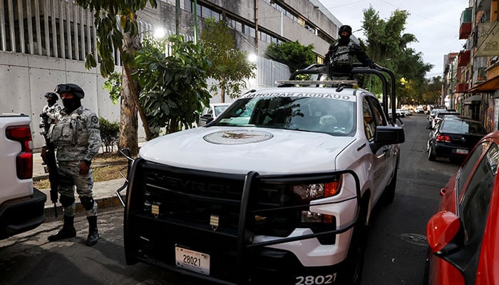 Members of the National Guard stand guard outside FEMDO where the body of El Mencho is suspected of being held by authorities on February 22, 2026. — Reuters